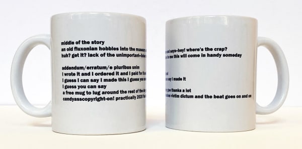 Two white coffee mugs with black text