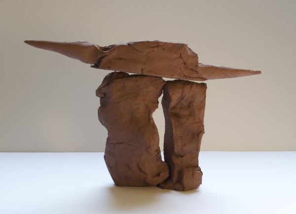 Terracotta sculpture of two cylindrical bases holding a long flat horizontal top