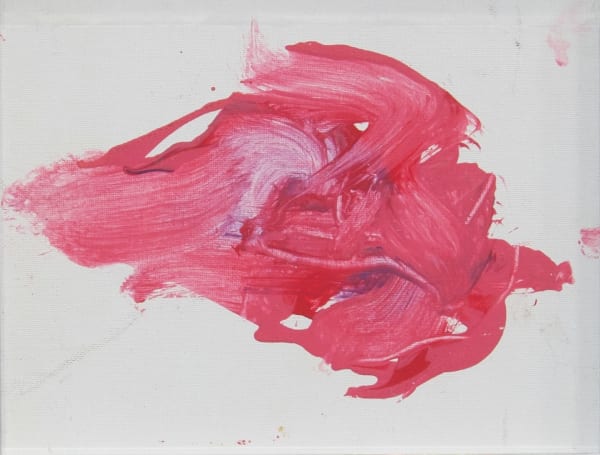 A red splotch of paint on white canvas