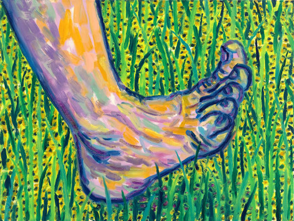 Painted foot in green and yellow grass