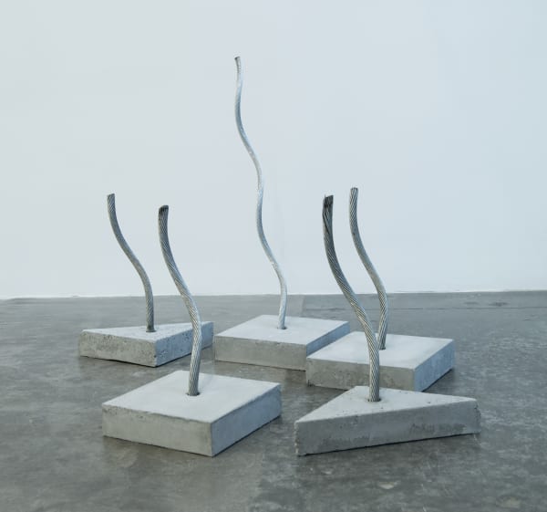 Various shaped cement slabs with wire sticking out