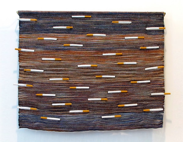 Woven wall hanging with cigarettes