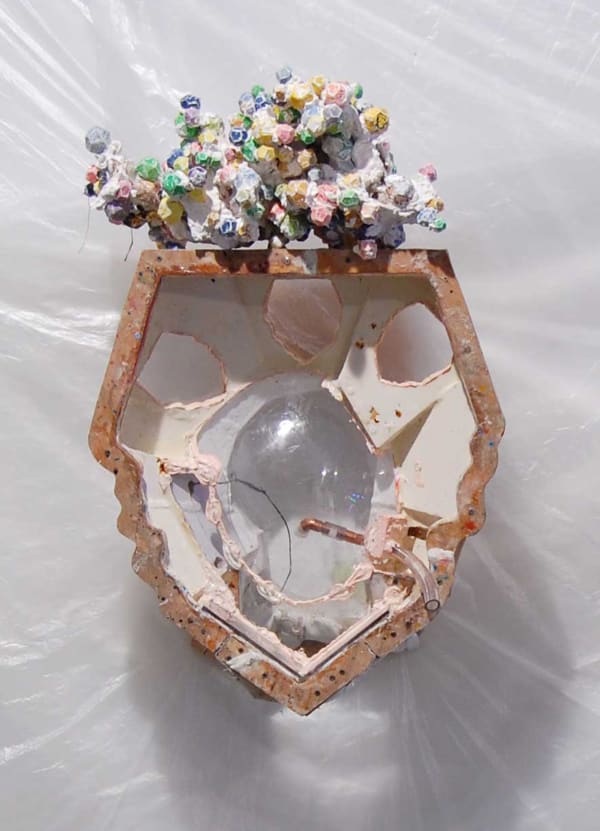 A sculpture with glass a orb in the center