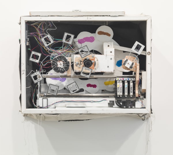 Abstract sculpture of white rectangle with multi colored elements inside