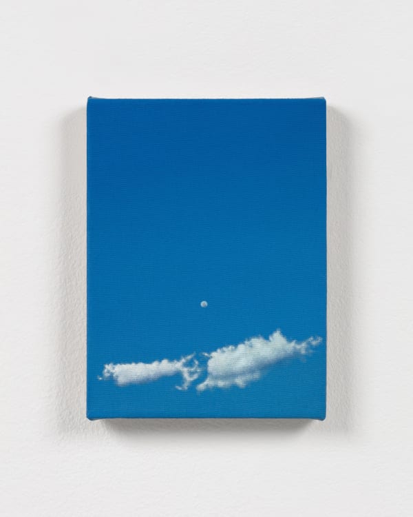 Dana Powell's painting of a small moon and clouds against a vibrant blue sky, hung on a white wall