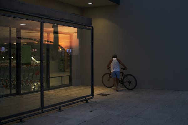 The Moment of Parking a Bike on The Supermarket’s Wall