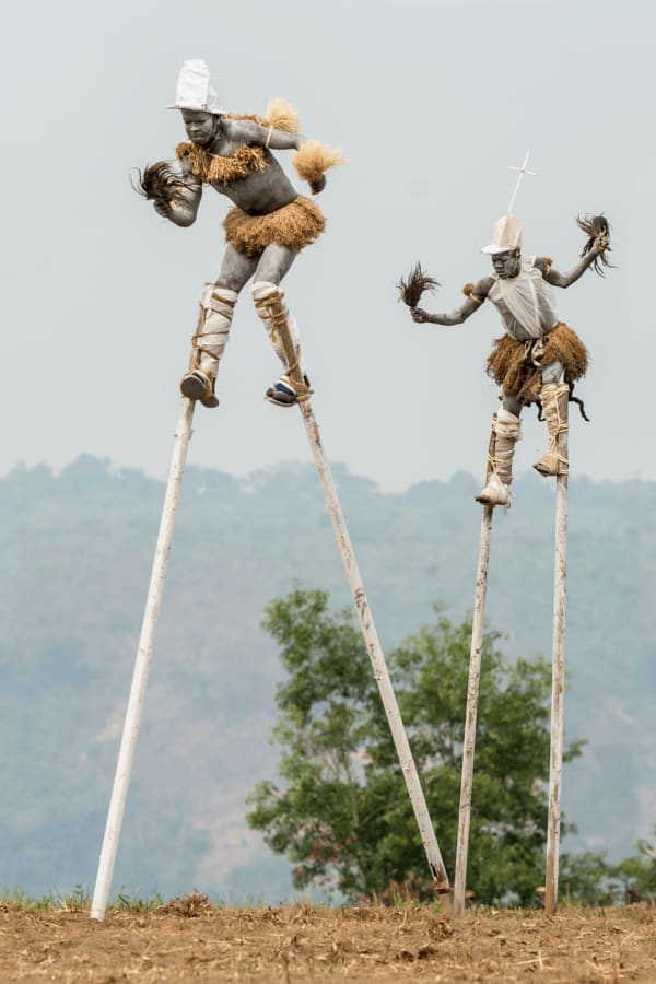 Carol Beckwith and Angela Fisher, Pende "Tall Men Walking" Stilt Dancers, Gungu, DR Congo, 2014