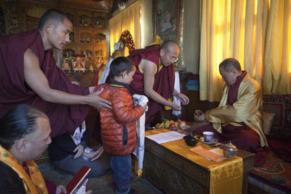 Briana Blasko, Chokyi Nyima Rinpoche with a young boy upon his initiation into monkhood Ka-Nying Shedrub Ling, Kathmandu, Nepal