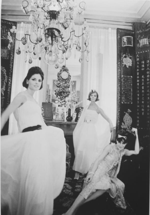 Black and white photograph of models wearing Chanel outfits from the 1962 collection as well as Jackie Rogers in Mademoiselle Chanel’s private apartment at the House of Chanel, Paris