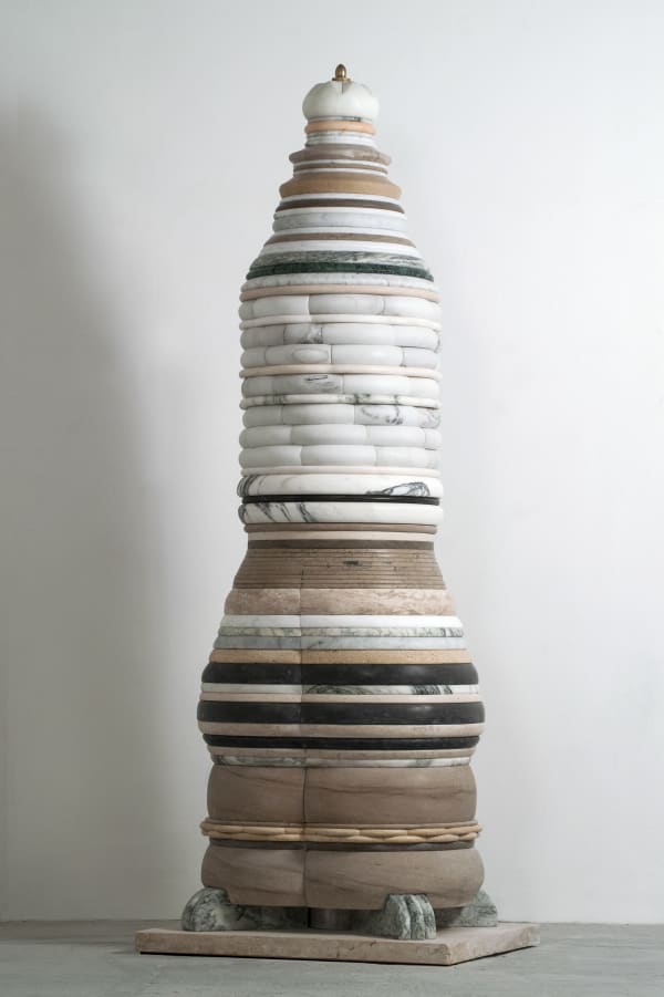 Larger layered sculpture, each layer is in neutrals and some patterns from the natural stones, the top piece is a small brass detail
