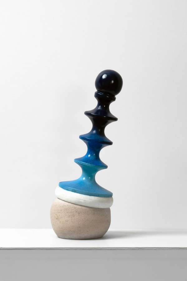 Contemporary minimalist sculpture made of stone and metal that resembles an ambiguous artifact