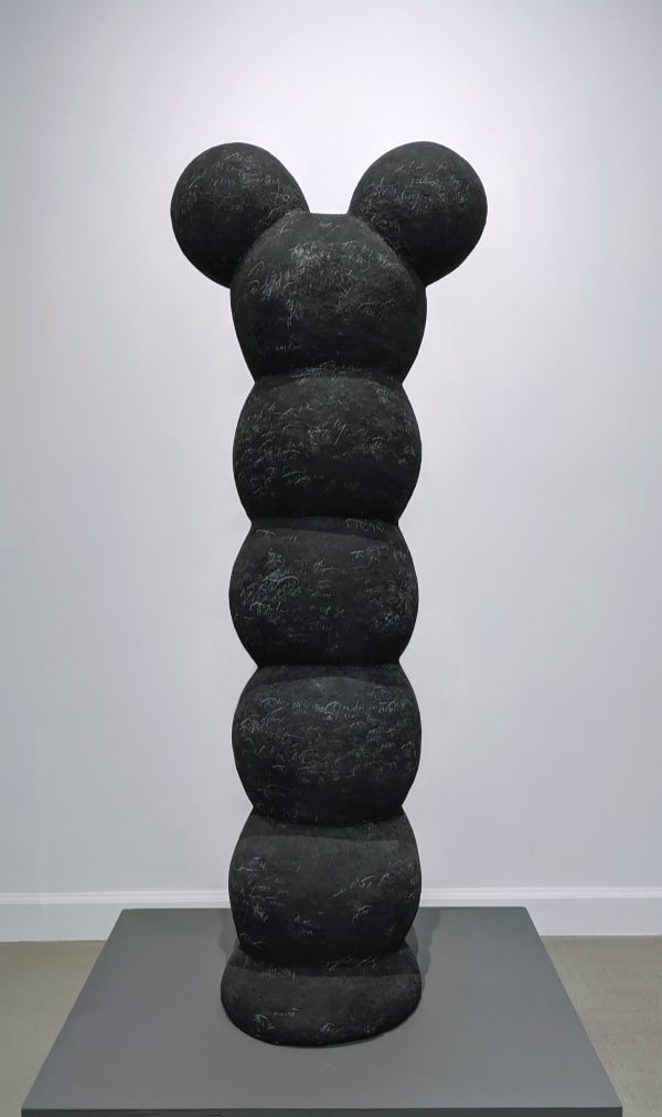 Black papier-mache sculpture of stacked spherical elements