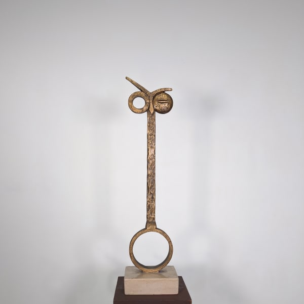 Modernist bronze sculpture of stylized owl represented by vertical bar, one eye open, one closed, on circular perch