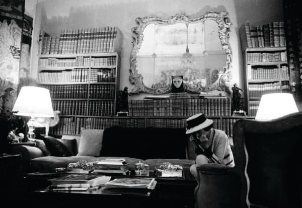 Black and white photograph of Designer Coco Chanel on the phone in her private apartment at the House of Chanel
