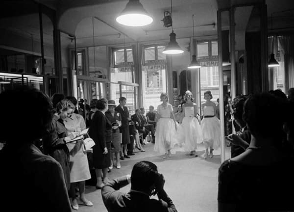 Black and white photograph of a fashion show in the House of Coco Chanel