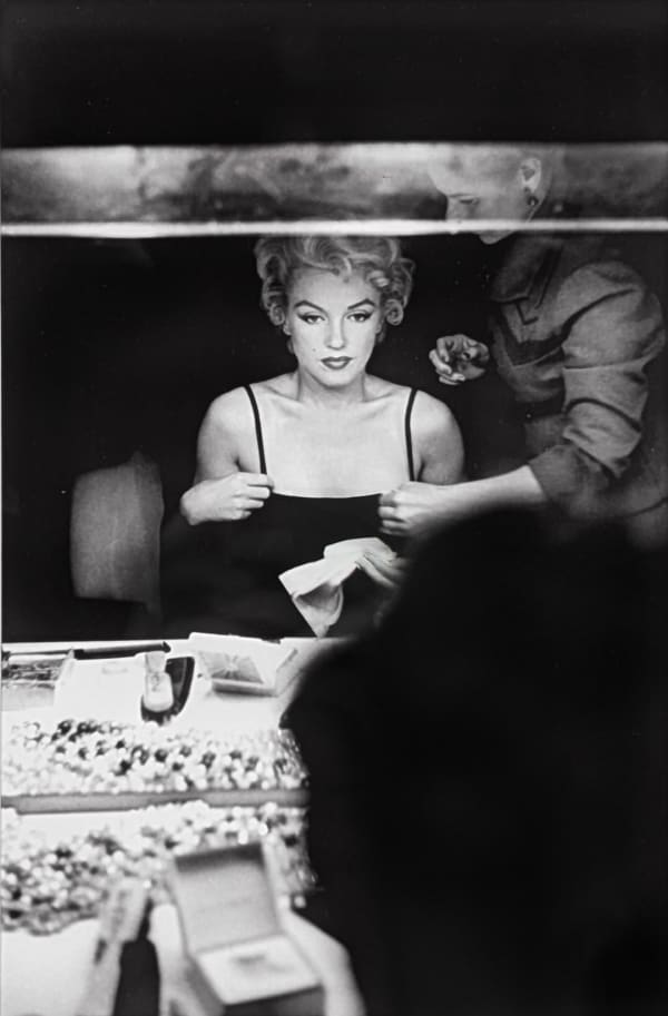 Marilyn Monroe looking at her makeup in the dressing room mirror of Carol Haney in New York City, 1954