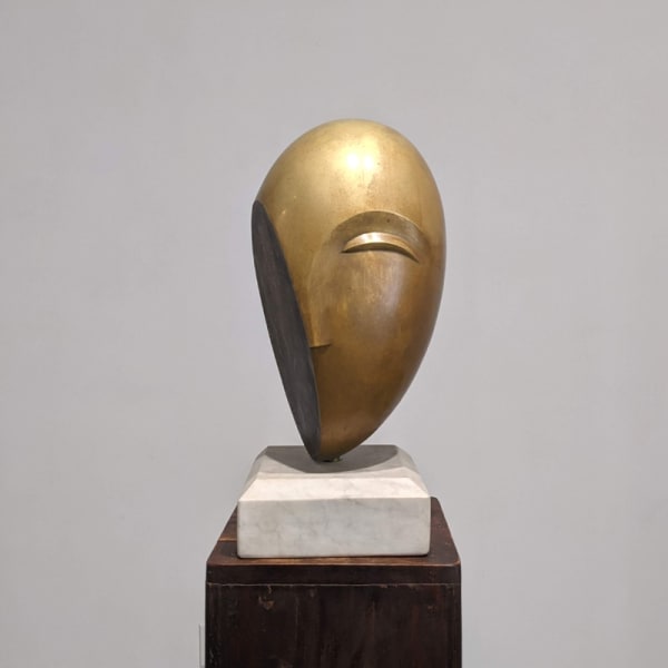 Modernist polished bronze sculpture of a head with stylized eyebrow and nose, cut in an angle on one side