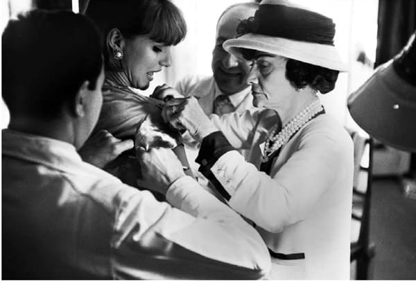 Black and white photograph of Coco Chanel at work in the atelier, House of Chanel, Paris