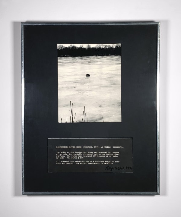 Black and white photograph of the Mississippi river with a darkened figure in the center and dark trees in the distance, surrounded by black and writing on the bottom