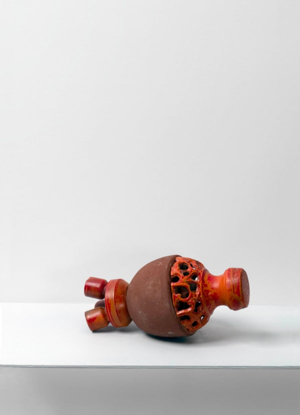 Contemporary minimalist sculpture made of stone and metal that resembles an ambiguous artifact