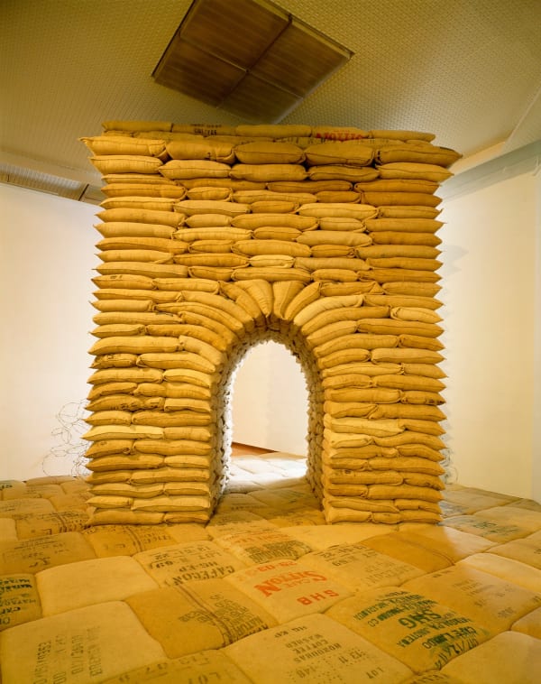 Art installation, large gate made of brown sandbags and barbed-wire, with sand-bag floor in the style of the Chain Bridge of Budapest