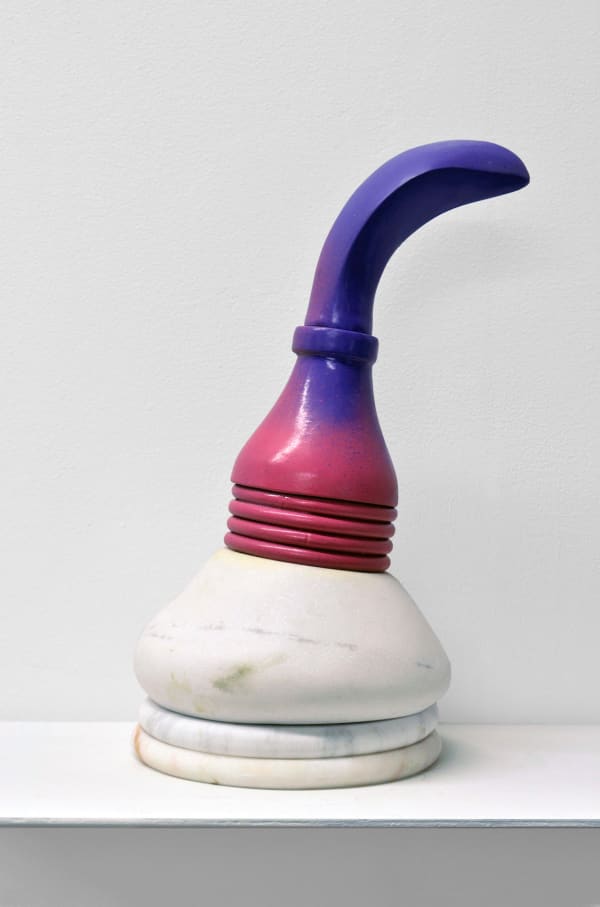 Contemporary minimalist sculpture made of stone and metal that resembles an ambiguous artifact