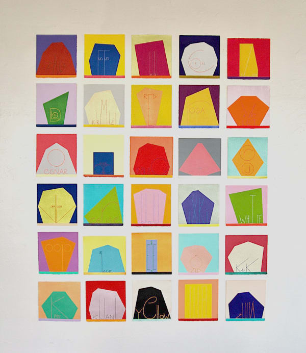 An array of colorful paintings comprised of geometric abstract forms displayed on a white wall