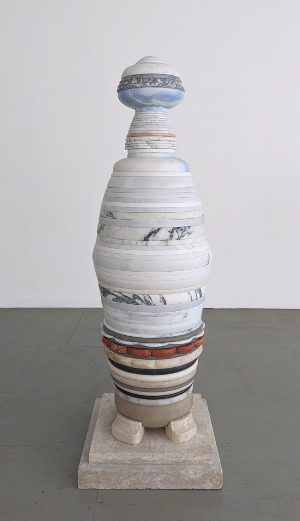 Multilayer sculpture made of marble with a limestone square base, four base stones, and layers in blue, whites, red, and black