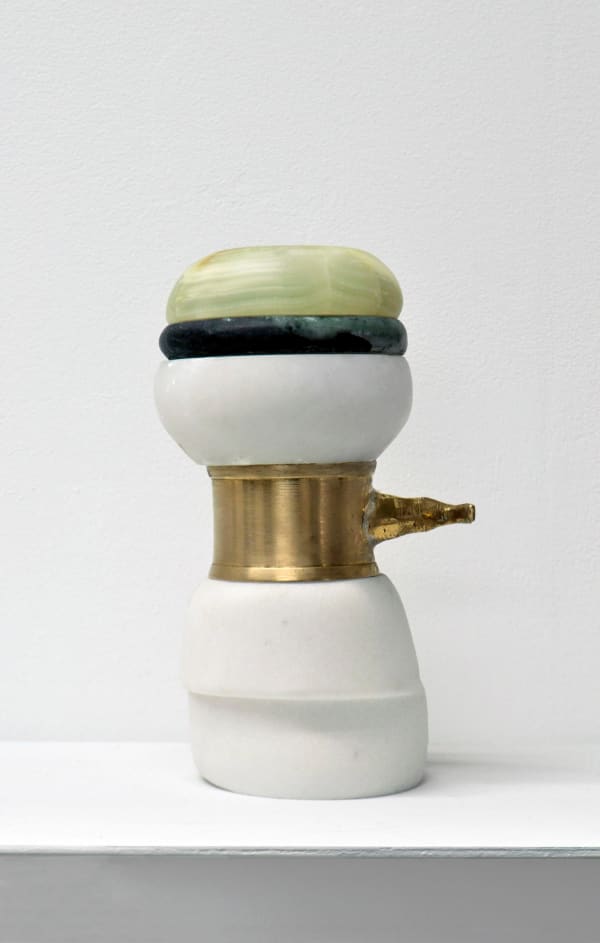 Contemporary minimalist sculpture made of stone and metal that resembles an ambiguous artifact