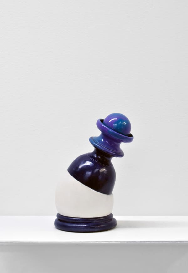 Contemporary minimalist sculpture made of stone and metal that resembles an ambiguous artifact