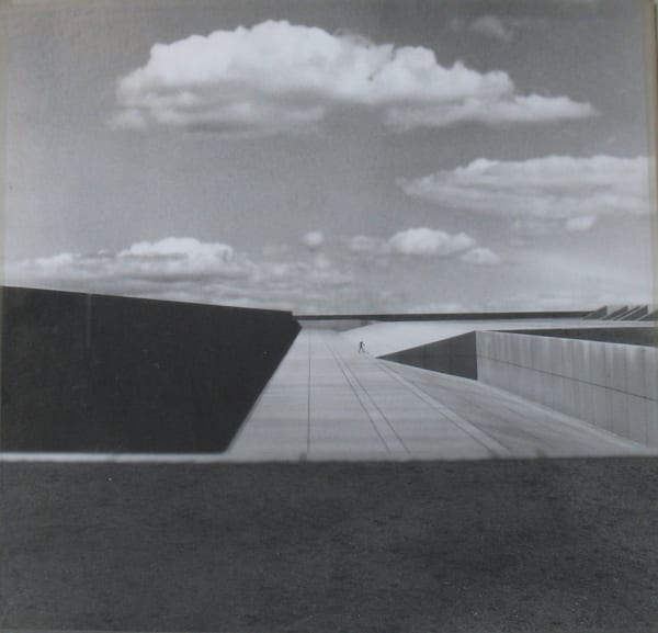 Black and white photomontage of an architectural structure and the sky