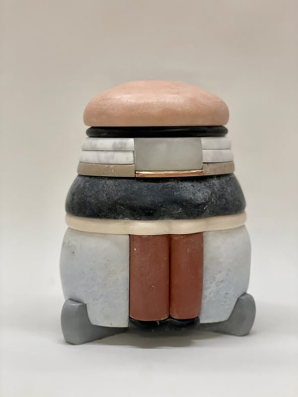 Layered marble sculpture with varying shades of circular marble and a blush pink domed top