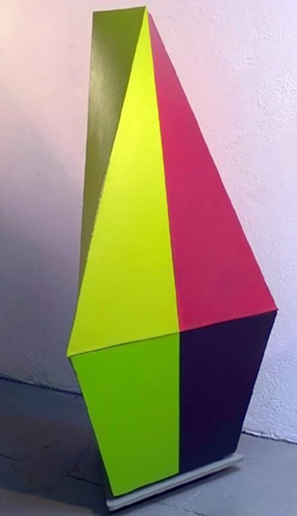 Tridimensional painting of a diamond shape with flat bottom edge with a lime green vertical color strip, a magenta triangle, and navy half trapezoid .