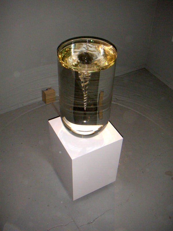 Boost in the Shell - The Pursued: exhibition view at De Bond, Bruges, 2005. Work: Petroc Sesti, Fluid Icon, 2005, plinth, turbine, glass, fluid, 182 x 50 x 50 cm Courtesy of Aeroplastics contemporary, Brussels