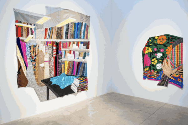Installation view of HANGAMA AMIRI’s (left) A.K. Fabric Shop, 2021, chiffon, silk, stain, muslin, cotton, lace, polyester, suede, paper, iridescent paper, denim, ikat printed fabric, faux leather, color pencil on fabric, velvet, camouflage, found fabric, 287 × 251.5 cm; and (right) Self-portrait with Afghan Suzani Textile, 2021, muslin, cotton, polyester, Afghan textile, silk, handmade ikat print, found fabric, 182.9 × 137.2 cm, at “Wandering Amidst the Colors,” albertz benda, New York, 2021. Photo by Casey Kelbaugh.