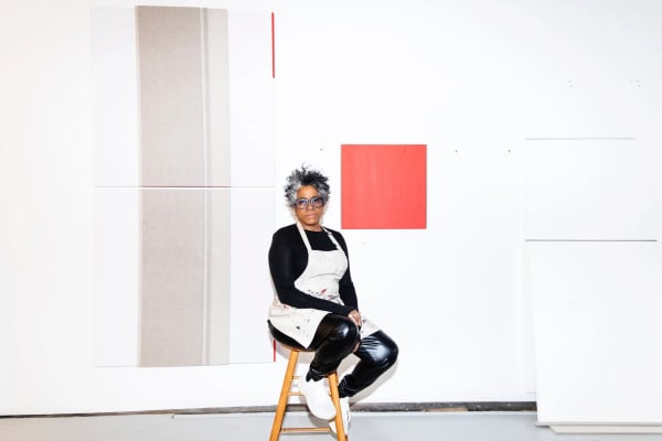 Jennie C. Jones in her studio in Hudson, N.Y., with recent works. The artist, who takes her inspiration from the history of Modernism and the Black sonic avant-garde, has a solo show, “Dynamics,” at the Guggenheim Museum. Credit: Lauren Lancaster for The New York Times