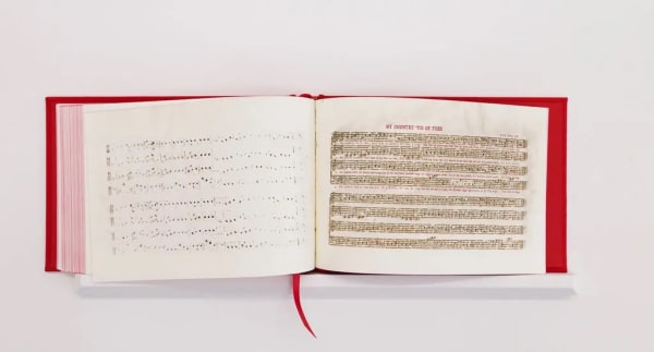 “America: A Hymnal” by Bethany Collins features a book printed with the lyrics of 100 different versions of “My Country, ’Tis of Thee.”Credit...Bethany Collins; Photo: Tim Johnson, via PEM