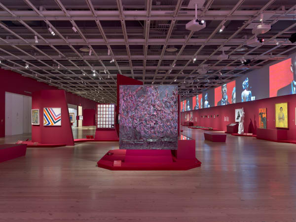 Installation view of Edges of Ailey (Whitney Museum of American Art, New York, September 25, 2024-February 9, 2025). From left to right: Norman Lewis, Phantasy II, 1946; Sam Gilliam, Swing 64, 1964; Bill Traylor, Untitled (Man in a Blue House), date unknown; Ralph Lemon, Bongos and Djembe, 1999; Ralph Lemon, Untitled (On Black music), 2001-07; Thornton Dial, Soul Train, 2004; Sam Doyle, Frank Capers, 2023; Sam Doyle, LeBe, 1970s; Wadsworth Jarrell, Together We Will Win, 1973; Faith Ringgold, United States of Attica, 1971; Wadsworth Jarrell, Revolutionary (Angela Davis), 1972; James Van Der Zee, Marcus Garvey Rally, 1924; Jeff Donaldson, Soweto/So We Too, 1979; Maren Hassinger, River, 1972/2012; Maren Hassinger, River, 1972/2012; Melvin Edwards, Utonga (Lynch Fragment), 1988; Aaron Douglas, Bravado, 1926; Melvin Edwards, Chitungwiza from the Lynch Fragment series, 1989; Aaron Douglas, Flight, 1926; Melvin Edwards, Katura from the Lynch Fragment series, 1986; Aaron Douglas, Surrender, 1970; Melvin Edwards, Cup of? From the Lynch Fragment series, 1988; In vitrine, from left to right: Elizabeth Catlett, I am the Negro Woman, 1947, printed 1989; Elizabeth Catlett, In Harriet Tubman I helped hundreds to freedom, 1946, printed 1989; Elizabeth Catlett, In Sojourner Truth I fought for the rights of women as well as Negroes, 1947, printed 1989; Elizabeth Catlett, In Phillis Wheatley I proved intellectual equality in the midst of slavery, 1946, printed 1989; From left to right: Kara Walker, African/American, 1998; Karon Davis, Dear Mama, 2024; Geoffrey Holder, Portrait of Carmen de Lavallade, 1976; Beauford Delaney, Marian Anderson, 1965; Loïs Mailou Jones, Jennie, 1943. Photograph by Ron Amstutz