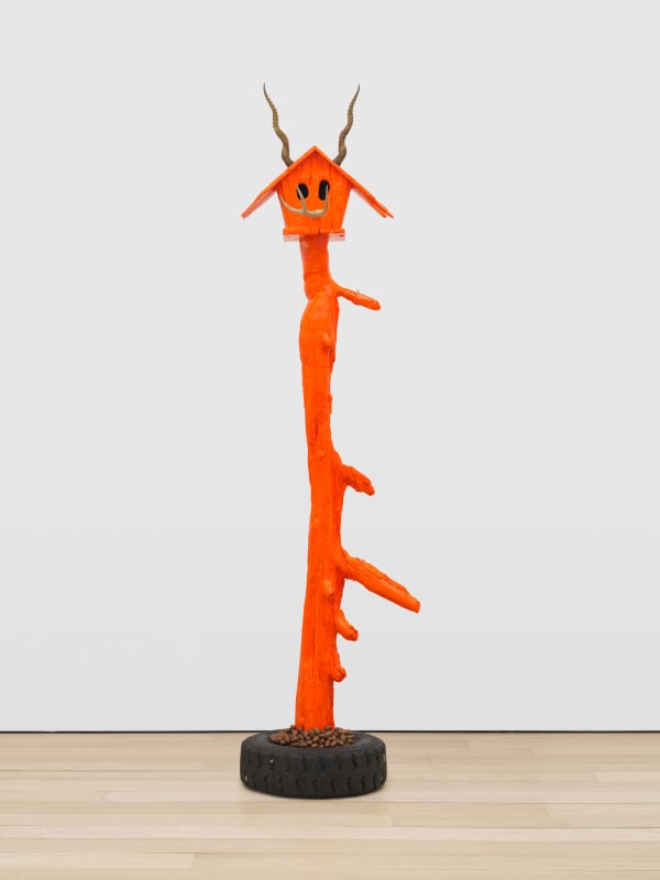 Lot 060624 (house, orange), 2024 Acrylic on wood, found deer antler, found antelope horns, found rubber tire with steel rim, and pecans 130 x 25 1/2 x 25 1/2 in (330.2 x 64.8 x 64.8 cm)