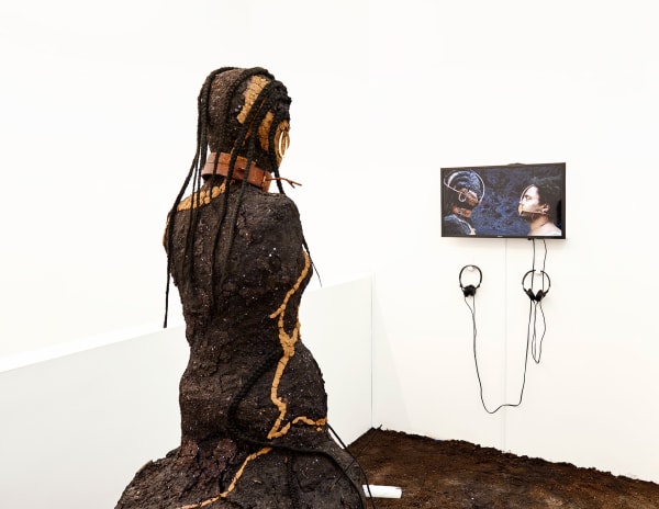 Kiyan Williams Dirt Eater, 2019 Sculpture and HD color video with sound, soil, clay, steel, patina, bricks, wax, kanekalon, incense, wood and steel armature 6 x 3 x 3ft Video: 7 minutes 29 seconds, loop Installation view In Practice: Other Objects, SculptureCenter, New York Photography by Kyle Knodell