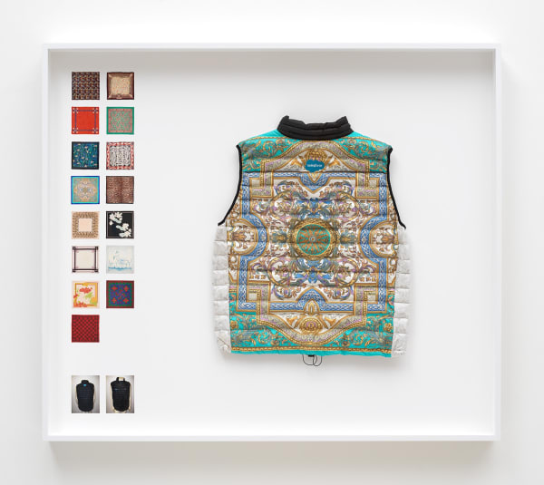 Simon Denny Power Vest 3, 2019 Scarf formerly owned by Margaret Thatcher, Patagonia M's Down Sweater Vest parts, Down sourced from second hand San Francisco garments, Ripstop Nylon, Salesforce and Quip embroidered logos, wood, glass, photo paper, cardboard 52 3/4 x 60 1/4 x 9 1/8 in 134 x 153 x 23 cm