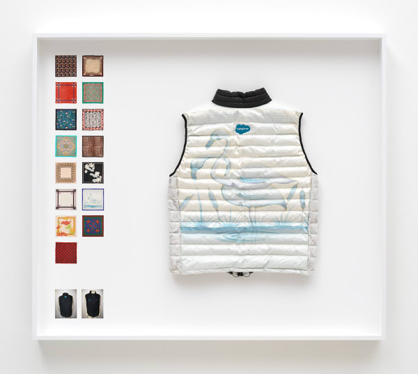 Simon Denny Power Vest 4, 2019 Scarf formerly owned by Margaret Thatcher, Patagonia M's Down Sweater Vest parts, Down sourced from second hand San Francisco garments, Ripstop Nylon, Salesforce and Quip embroidered logos, wood, glass, photo paper, cardboard 52 3/4 x 60 1/4 x 9 1/8 in 134 x 153 x 23 cm