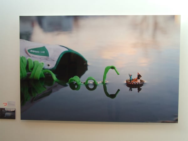 Slinkachu print hanging in exhibition.