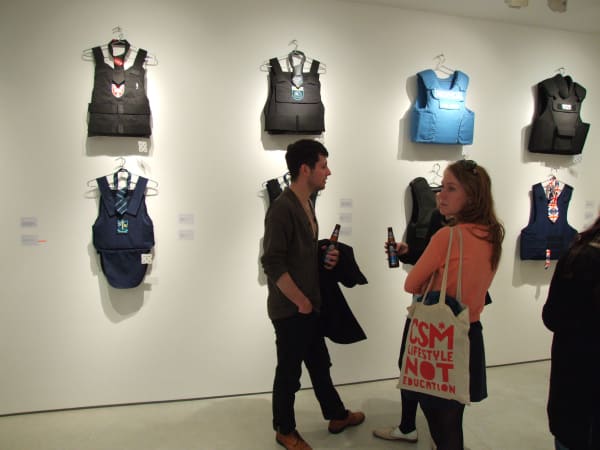 Banksy War Boutique exhibition hanging at Andipa Gallery with two people in front