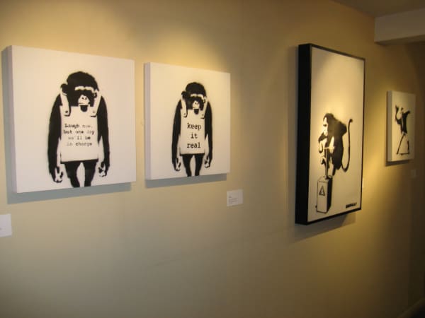 Banksy artworks hanging on wall