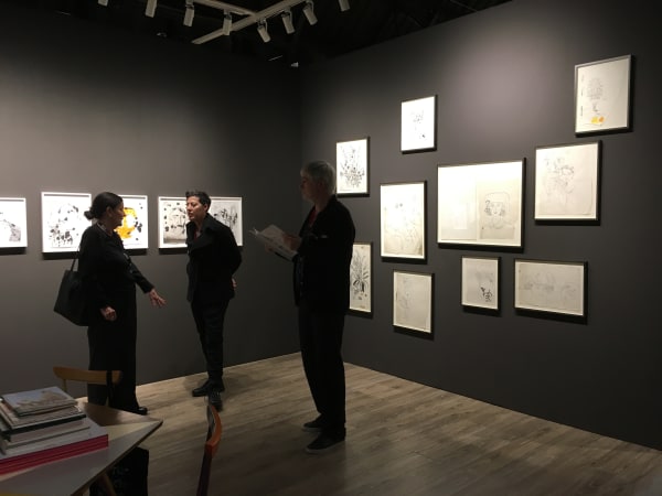 Nicole Eisenman and Andy Warhol dual booth at ADAA. Dark walls populated with drawings by the two artists.