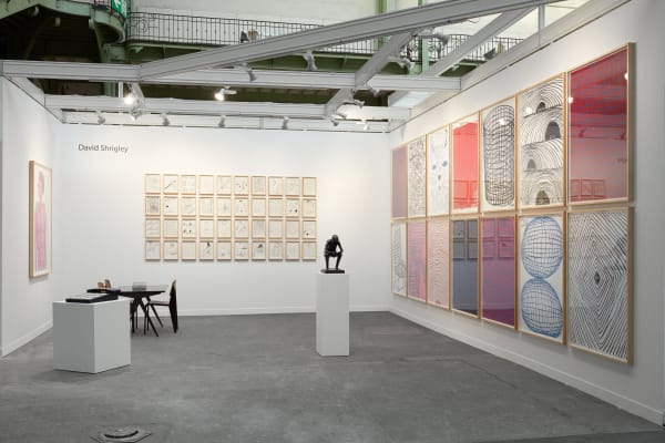 Solo booth of colorful David Shrigley paintings and sculptures.