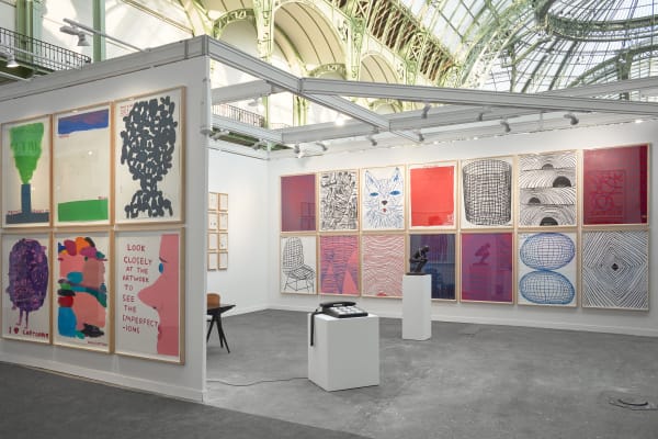 Solo booth of colorful David Shrigley paintings and sculptures.