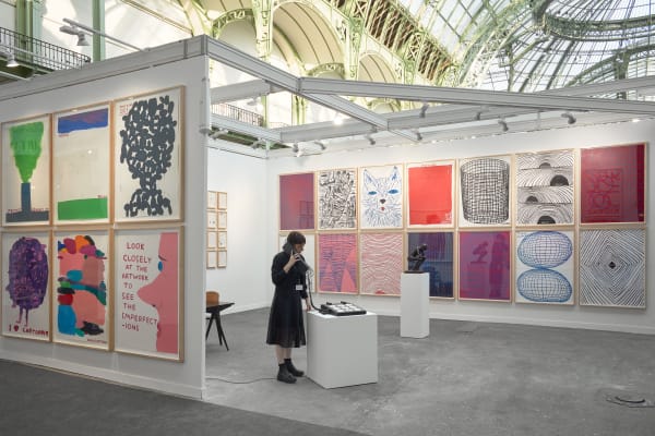 Solo booth of colorful David Shrigley paintings and sculptures.