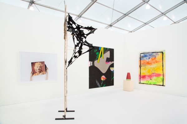 Group booth installation with gallery artists, including Anne Collier photography and Lara Schnitger's sculpture.